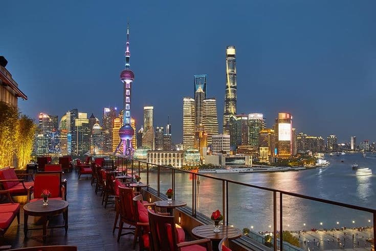 Shanghai skyline at night with illuminated rooftop bars